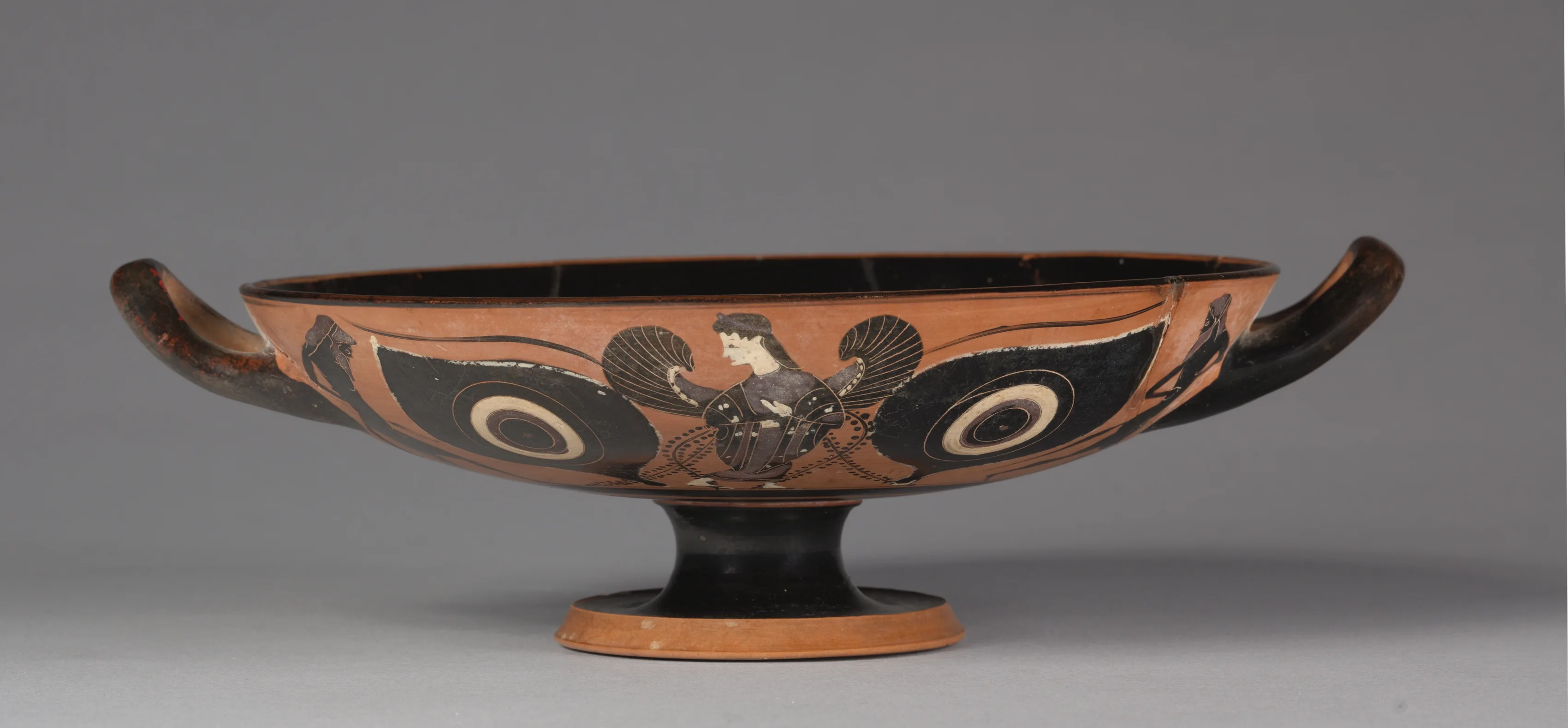 Black-Figure Eye Cup_ Iris and Satyrs (A, B); Gorgoneion (I).jpeg